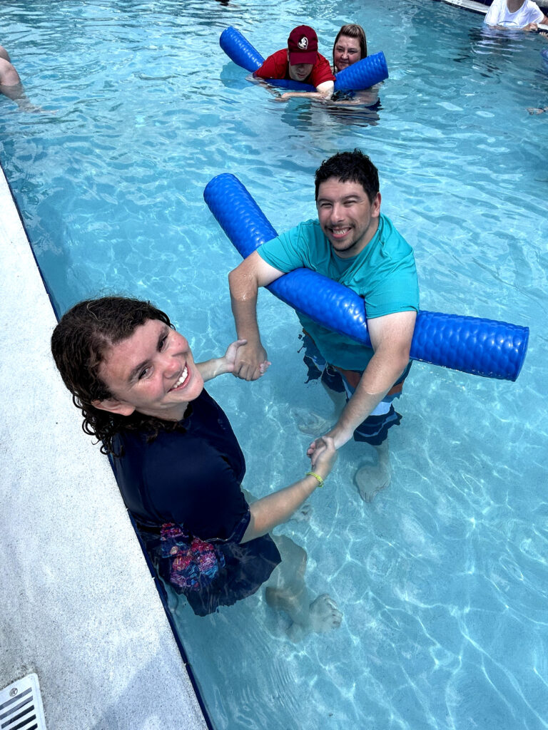 Independence Landing - Resident having a swim in the pool guided by a staff member