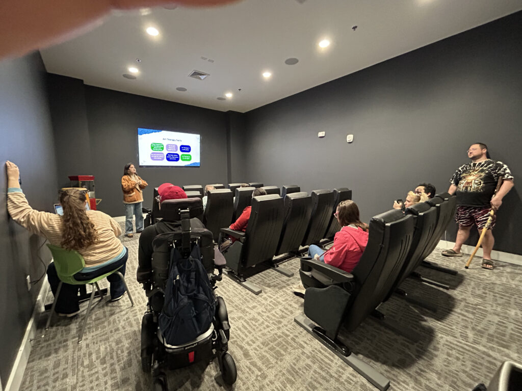 Independence Landing - Resident theathre room, full of residents watching a presentation