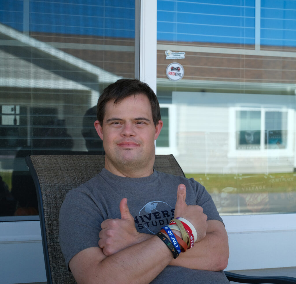 Independence Landing - Happy resident posing for picture on the front porch