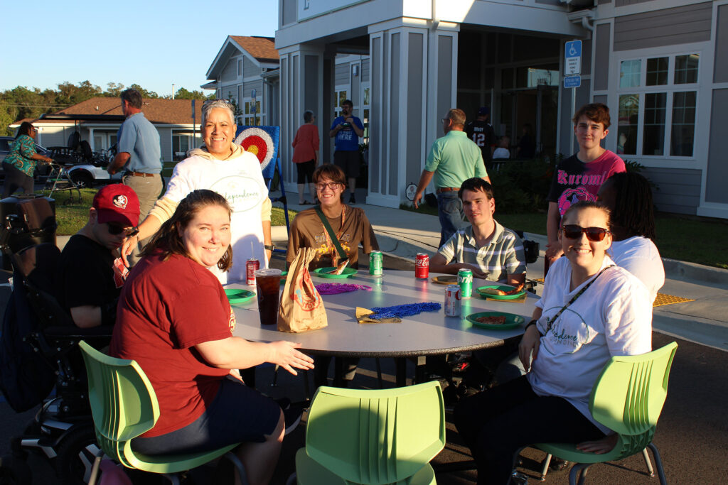 Independence Landing - Residents gathered at a table in front of the building